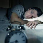 Man In Bed With Eyes Opened Suffering Insomnia And Sleep Disorde