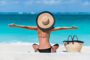 Summer vacation happy carefree joyful bikini woman arms outstret