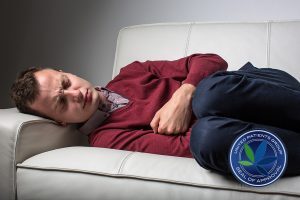 Young man suffering from severe belly pain