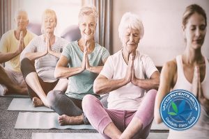 Instructor performing yoga with senior citizens