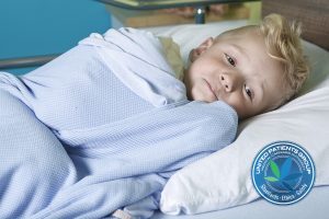 sick little boy in a hospital bed